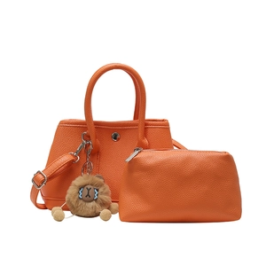 Set aus orangefarbener Leder-Tragetasche mit kleiner Tasche und Plüsch-Anhänger