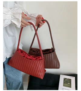 Detail of hand-woven leather hobo bags with inner drawstring liner in burgundy and brown