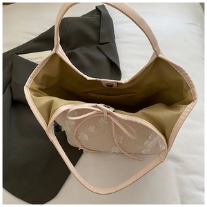 Detail view of pink floral canvas tote with inner zipper pocket and drawstring closure