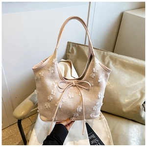 Detailed close-up of a floral canvas tote bag with 3D flower appliqués and bow detail