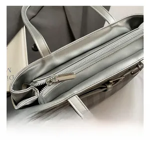 Detail shot of the metallic zipper and premium hardware on the silver checkered baguette bag