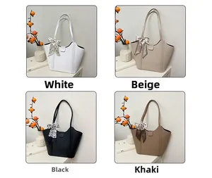 Detail view of large tote bags in four colors with decorative silk scarves and lychee grain