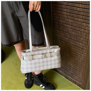 Detail of silver gray checkered baguette bag featuring adjustable metal buckle and dual straps