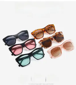 Flat lay of geometric polygon sunglasses in various colors and patterns on white background