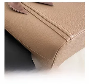 Detailed close-up of the precise stitching on the camel textured grain leather tote bag