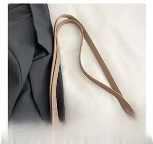 Detail of lychee pattern leather shoulder strap with stylish leopard print silk scarf decoration