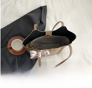 Top view of spacious tote bag interior with leopard scarf and dual compartments