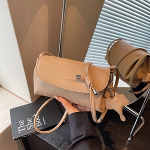 Chic pebble leather underarm bag in beige with minimalist flap and cute elephant charm