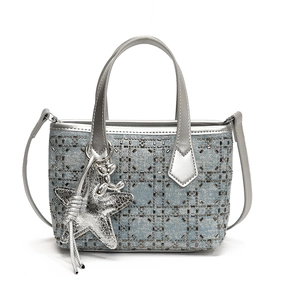 Blue denim bucket bag with sequin grid pattern and star charm on white background