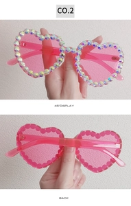 Detailed views of heart-shaped pink sunglasses with sparkling AB rhinestones
