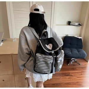 Fashionable black canvas backpack with heart patch and stylish plaid side pockets