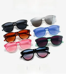 Detail of oversized rimless sunglasses in multiple colors with metallic rivet accents