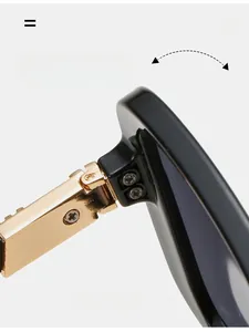 Detail of durable gold metal hinge with double screw fixings on black sunglasses