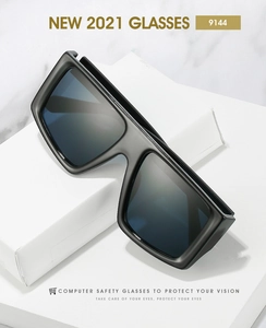 Detail of matte black oversized computer safety glasses with blue reflective lenses