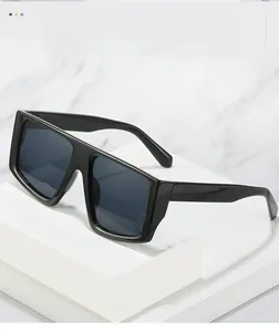 Detail of glossy black oversized square frame sunglasses with thick edges on display