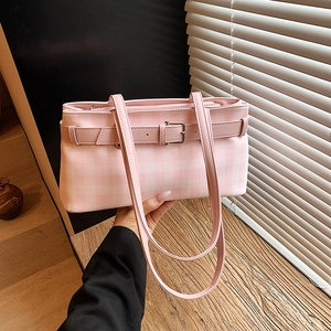 Pink checkered baguette underarm bag with decorative leather strap and silver buckle