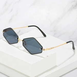 Lunettes de soleil hexagonales minimalistes avec monture dorée et verres dégradés bleu foncé