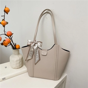 Minimalist beige pebble leather tote bag with heart pattern scarf and textured finish
