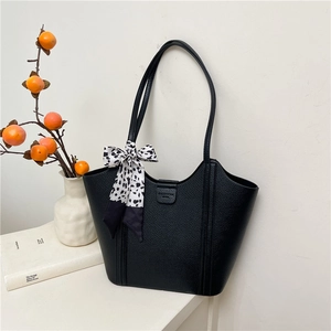 Minimalist black lychee leather tote bag with polka dot scarf detail and fashion buckle