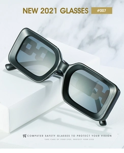 Macro view of rectangular black thick-frame computer glasses on white marble base