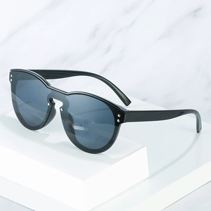 Fashion oversized black frame sunglasses with deep gray lenses on marble background