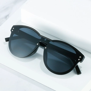 Oversized black frame sunglasses with silver rivet accents and V-shaped bridge design