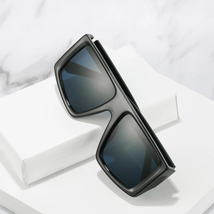 Retro oversized square Y2K sunglasses with black thick frame shown on a marble surface