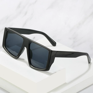 Oversized Y2K punk square sunglasses in classic black displayed on geometric props
