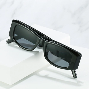 Retro rectangle thick frame sunglasses with dark grey lenses on white display blocks