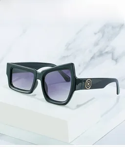 Detail of geometric black sunglasses with gradient purple lenses and gold temple rings