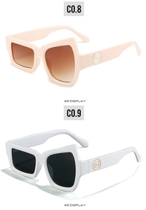 Detail view of bold irregular wide-frame sunglasses in beige and white from a 45-degree angle