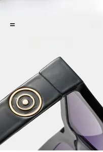 Detail of black sunglasses featuring a gold hinge accent and super elastic frame