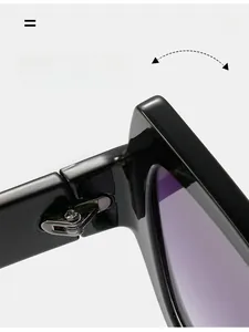 Detailed close-up of durable metal hinge on black frame sunglasses with gradient lenses