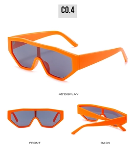 Detailed views of orange oversized shield sunglasses with Y2K style and dark lenses