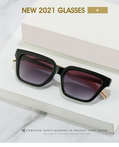 Detail of square sunglasses with gold metal accents and purple gradient lenses