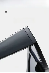 Detail of high-gloss oversized sunglasses frame showing hinge and premium material texture