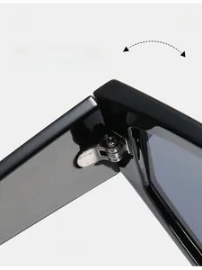 Macro view of durable metal reinforced hinge on black oversized retro sunglasses
