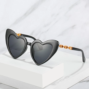 Fashionable heart-shaped sunglasses with orange chain temples and black frames