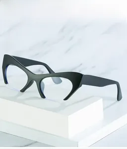 Detail of black cat-eye semi-rimless frames on a modern white display stand