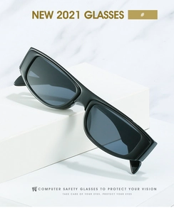 Detail of modern black rectangular sunglasses with grey lenses on a minimalist white stand