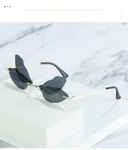 Detail of grey dragonfly wing lenses with intricate textures and gold metal frames