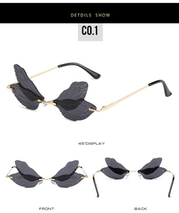 Detail view of dragonfly wing sunglasses featuring gray lenses and gold metal frames