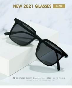 Detail view of square black computer safety glasses on a white geometric stand