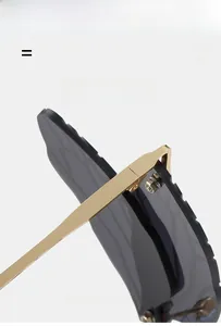 Detail of golden metal hinge and wavy-edged dark gray lenses on dragonfly sunglasses