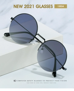 Macro shot of retro round black metal sunglasses with dark grey gradient lenses