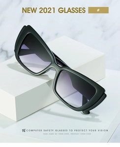 Detail of oversized black frame glasses with purple gradient lenses on marble background