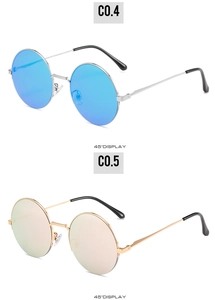 Detail view of retro round sunglasses with blue and champagne mirrored lenses and metal frames