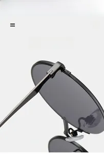Detail shot of black metal hinges and elastic temples on round fashion sunglasses