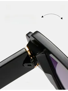 Close-up of durable golden metal hinge on polished black cat-eye sunglasses frame