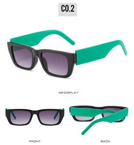 Detail view of rectangular sunglasses with black frame, green temples and purple gradient lens